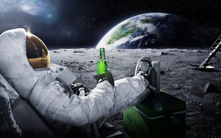 Astronaut holding a beer sat watching the earth on holiday