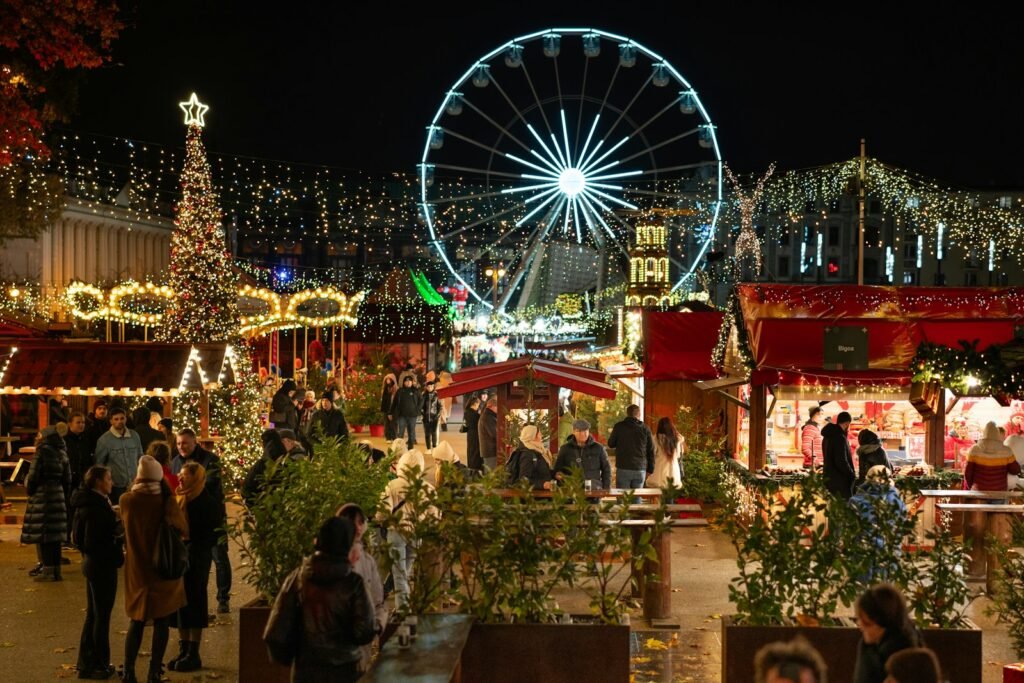 A Christmas market with a ferris wheel in the background